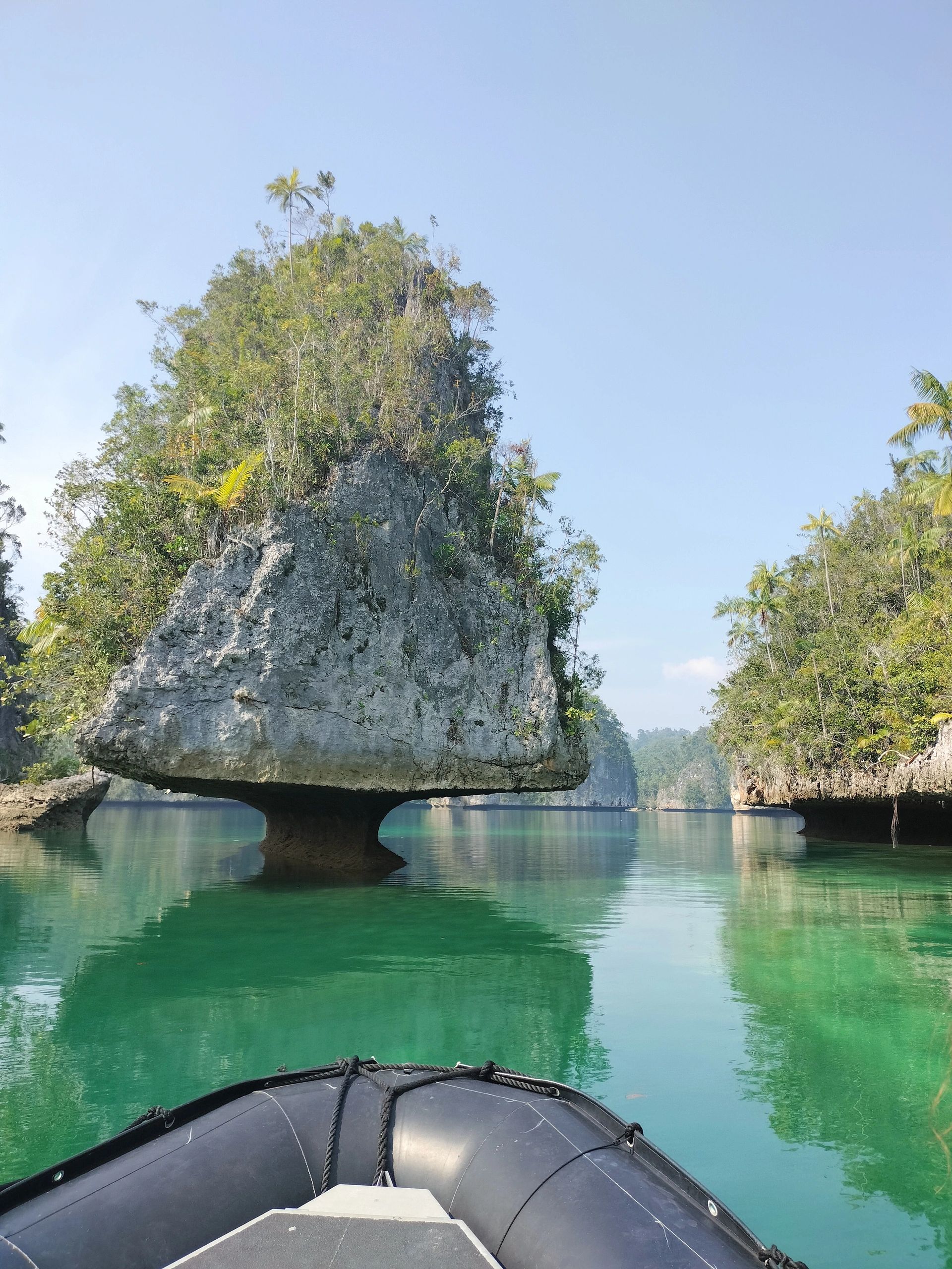 Tropical limestone rock arch with turquoise water